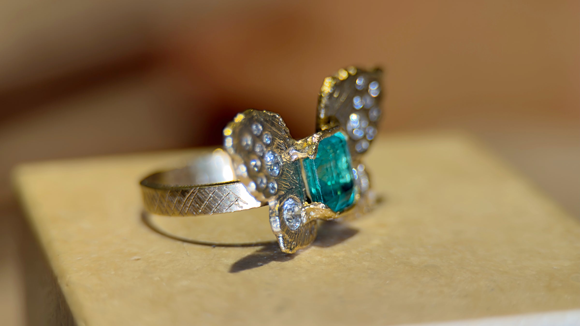 IGI Certified 1.3 Ct Emerald Queen Butterfly Ring with Diamonds in 18 Ct Gold Half Bezel (Available online and also to View in Person at Stardust, London 101 Walton Street)