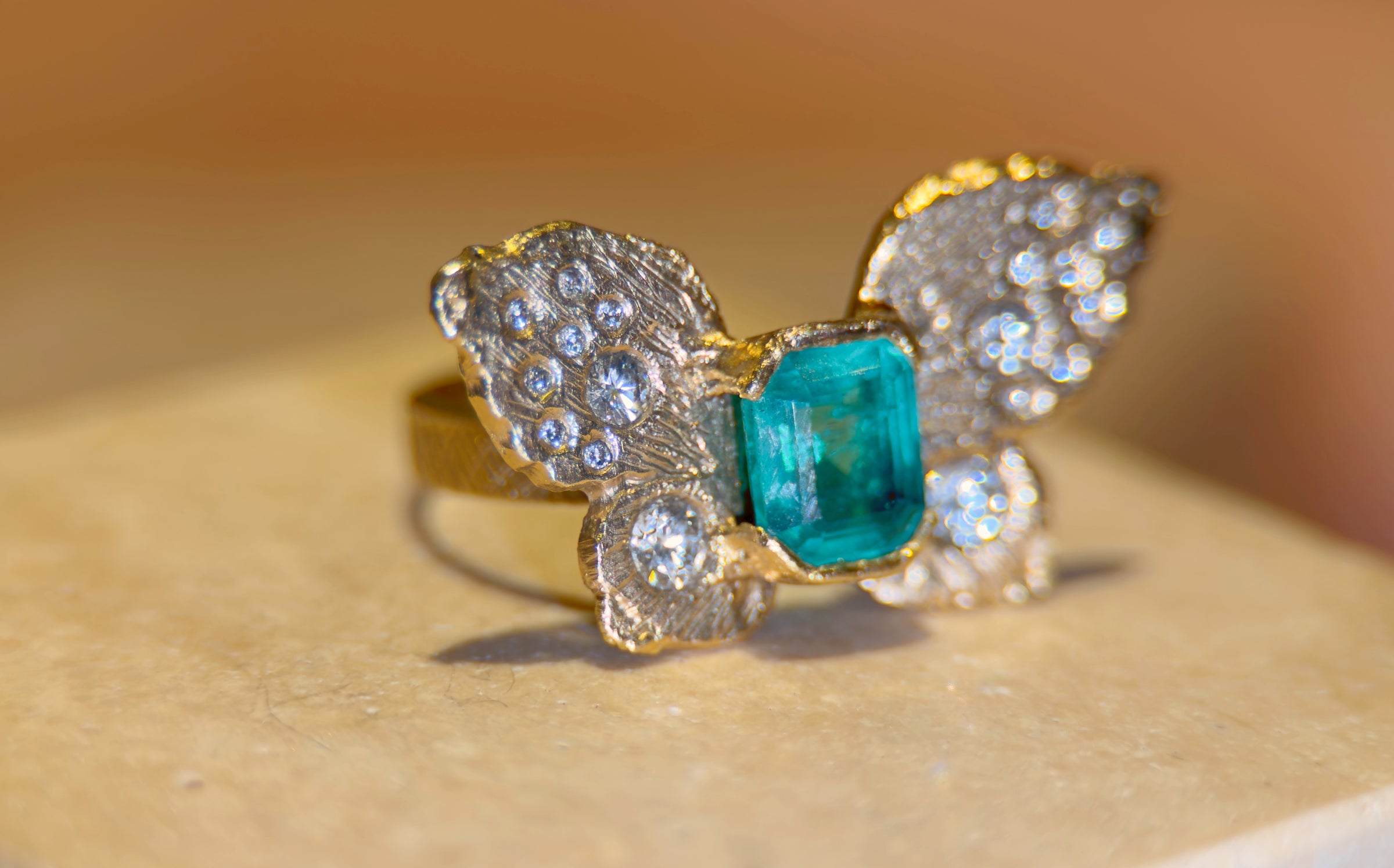 IGI Certified 1.3 Ct Emerald Queen Butterfly Ring with Diamonds in 18 Ct Gold Half Bezel (Available online and also to View in Person at Stardust, London 101 Walton Street)