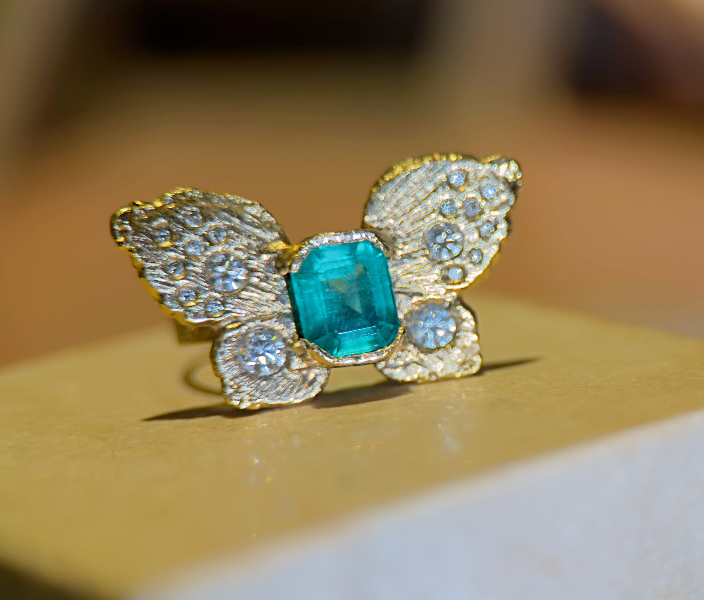 IGI Certified 1.3 Ct Emerald Queen Butterfly Ring with Diamonds in 18 Ct Gold Half Bezel (Available online and also to View in Person at Stardust, London 101 Walton Street)